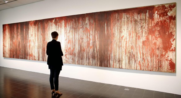epa04336643 A visitor stands in front of the painting 'Untitled (Kreuzbluttriptychon 1)' by Austrian artist Hermann Nitsch at the 'Kunsthalle' in Hamburg, Germany, 31 July 2014. The Hamburg Kunsthalle is remaining open despite modernization works. Some 200 masterpieces from the museum's permanent collection will be on display under the title 'Spot On' at the Kunsthalle's 'Galerie der Gegenwart' (Galery of Contemporary Art) until 03 January 2016. EPA/MALTE CHRISTIANS